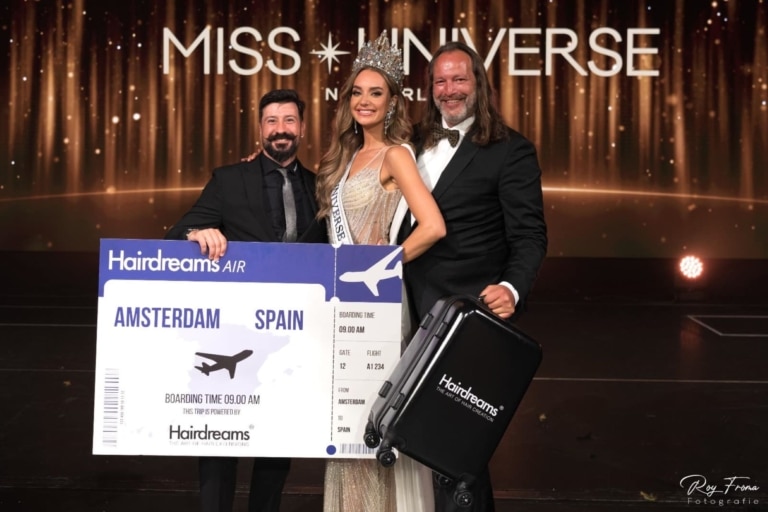 The new Miss Universe with representatives of Hairdreams on stage.