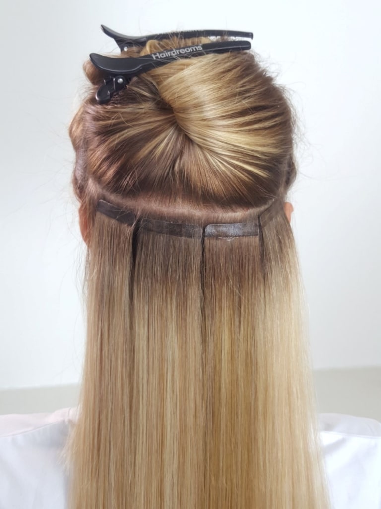 Four Quikkies Tape-Extensions are attached to a customer's own hair