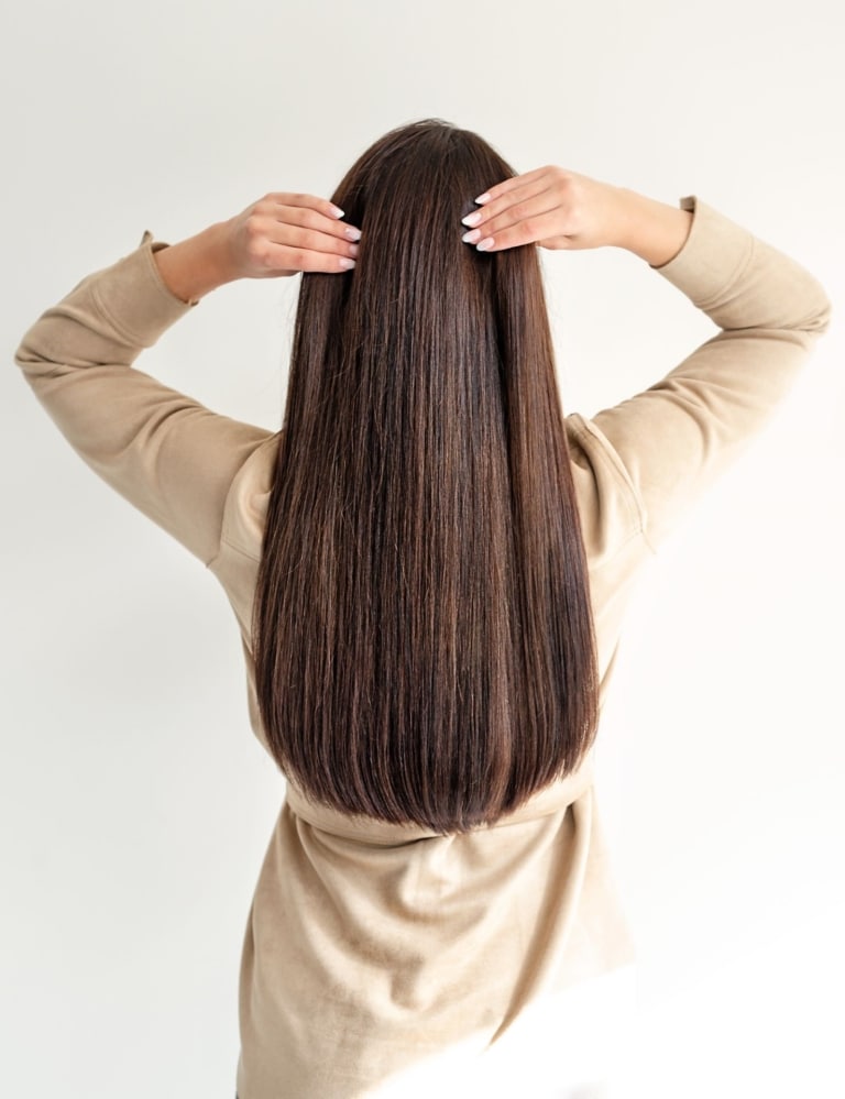 Woman with long brown hair from behind